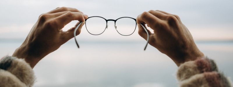 Personal Vision Statement represented by a person holding glasses