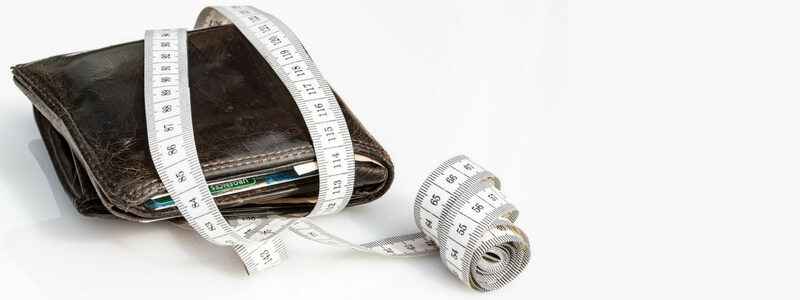 A wallet wrapped in measuring tape symbolizes how much money really does (or doesn't) matter