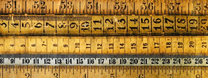 Measurable vs quantifiable goals represented by a series of well-worn measuring sticks